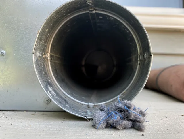Lomita Dryer Vent Cleaning technician using specialized equipment to clear severe dryer vent blockage in Lomita